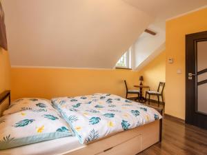 a bedroom with a bed and a table and chairs at Holiday Home Villa von Valdi by Interhome in Władysławowo