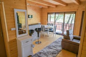 a log cabin with a kitchen and a living room at Hakuna Matata Lake House in Jajce
