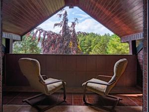 two chairs in a room with a large window at Holiday Home Villa Bieszkowice by Interhome in Bieszkowice