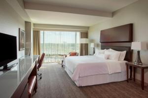 um quarto de hotel com uma cama e uma grande janela em The Westin Wilmington em Wilmington