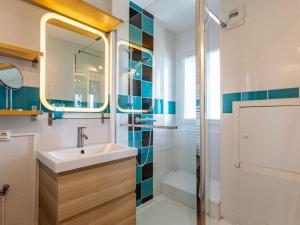 a bathroom with a sink and a shower at Apartment La Bizontine by Interhome in Cabourg