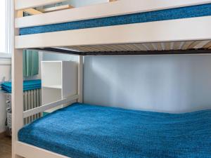 a bunk bed in a bedroom with a blue mattress at Apartment La Bizontine-9 by Interhome in Cabourg +16 photos