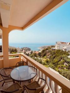 a balcony with a table and chairs and the ocean at Apartments Albin in Ulcinj
