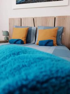 Cama azul con sábanas azules y almohadas amarillas en Sunny Apartment Costa Blanca, en La Mata