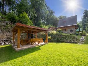 a wooden gazebo in a yard with a house at Chalet Mrklov by Interhome in Mrklov