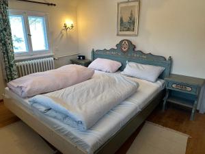 a bed with two pillows on it in a bedroom at Holiday Home Kesslerberg by Interhome in Hinterzarten