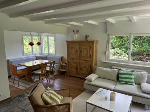 a living room with a couch and a table at Holiday Home Kesslerberg by Interhome in Hinterzarten