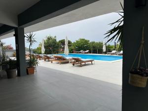 a patio with benches and a swimming pool at Dela in Hvar