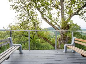 two benches sitting on a wooden deck with a tree at Holiday Home Achmony Type 2-1 by Interhome in Drumnadrochit