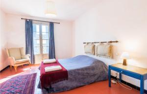 a bedroom with a bed and a desk and a chair at 4 Bedroom Lovely Home In Magalas in Magalas