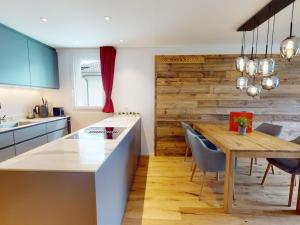a kitchen with a wooden wall and a wooden table at Apartment Uehlinger La Riva 307 by Interhome in Lenzerheide