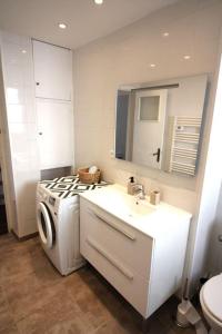 a kitchen with a washing machine and a sink at Charming & quiet appart 5 mns from downtown in Cannes