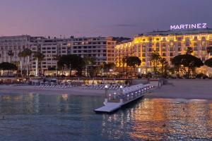 a large building with a dock in a body of water at Charming & quiet appart 5 mns from downtown in Cannes