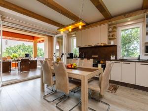 a kitchen and dining room with a wooden table and chairs at Apartment Zen by Interhome in Révfülöp