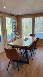 a dining room with a glass table and chairs at Holiday home Villa Esteri in Pyhätunturi