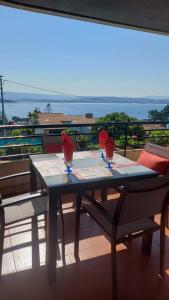 a table with three wine glasses on top of a balcony at Estupendo apartamento en San Vicente do Mar O Grove in San Vicente do Mar