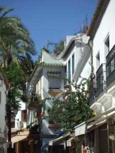 a white building with a tree in front of it at Old town Marbella home in Marbella