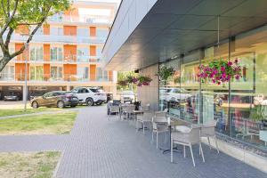 a restaurant with tables and chairs outside of a building at Bluetique Studio of Palanga in Palanga