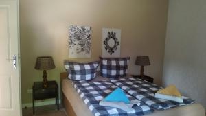 a bedroom with a bed with blue and white pillows at Ferienwohnung mit Kamin und traumhafter Dachterrasse mit Weitblick in die Natur in Neu Gaarz