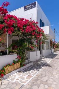 a building with pink flowers on the side of it at Hotel Antiparos in Antiparos
