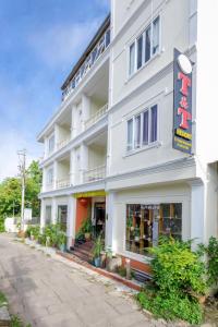 a white building with a sign on it at T&T Resort And Spa in Phú Quốc