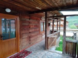 an outside view of a wooden house with a door at Casa Godja Oncesti in Onceşti