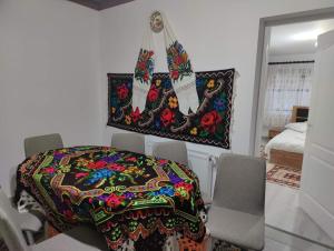 a room with a table with a colorful table cloth at Casa Godja Oncesti in Onceşti
