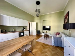 a kitchen and living room with a couch and a table at Das Domizil in Klagenfurt