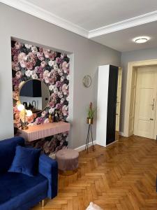 a living room with a blue couch and a mirror at Premium Apartment in Spiski Palace in Krakow