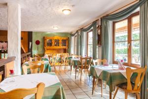 ein Restaurant mit Tischen, Stühlen und Fenstern in der Unterkunft Tonis Tenne in Eschbach