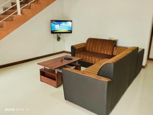 a living room with a couch and a coffee table at New White House in Colombo