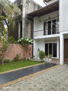 a house with a walkway in front of it at New White House in Colombo
