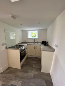 a kitchen with a sink and a stove top oven at Abbeville in Two Dales