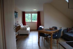 a living room with a table and a couch at Ferienoase Hinterhermsdorf in Hinterhermsdorf