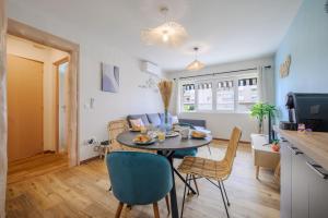 a kitchen and living room with a table and chairs at Nouveau - L'Azur - Plage 100mètres in Cagnes-sur-Mer