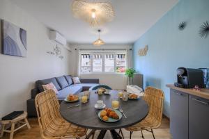 a living room with a table with food on it at Cosy Morning - L'Azur - Plage 100mètres in Cagnes-sur-Mer