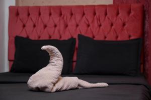 a stuffed animal snake laying on a bed at Castle Hotel in Cairo