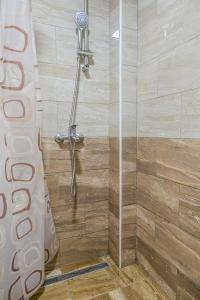 a shower with a glass door in a bathroom at Forest Dream Lake House in Jajce