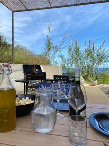 a table with wine glasses and a bowl of food at Casello 79 Rais in Finale +31 photos