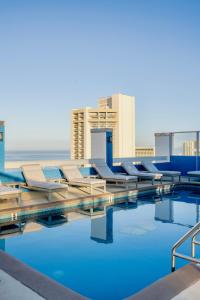 a swimming pool on the roof of a building at Pacific Monarch Hotel in Honolulu