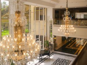 Habitación grande con lámparas de araña y mesa. en Karachi Marriott Hotel, en Karachi