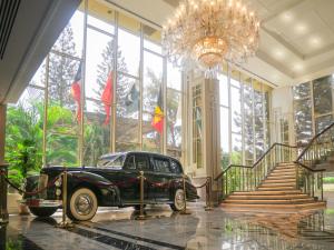 an old car parked in a lobby with a chandelier at Karachi Marriott Hotel in Karachi