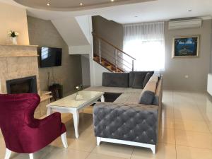 a living room with a couch and a table at Luxury Villa with Private Pool and Jacuzzi in Mostar
