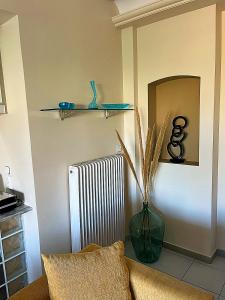 a living room with a radiator and a vase at AM Apartment on the beach in Lefkandi Chalkidas