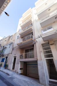 a building on a street with a building at Sant Antnin in Sliema