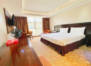 a hotel room with a bed and a television at Boma Inn Eldoret in Eldoret