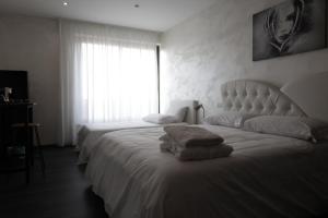 a hotel room with two beds and a window at Punta Piana b&b in Palmi +53 photos