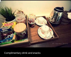 a wooden tray with cups and saucers on a table at 37 Nature House in Bangkok