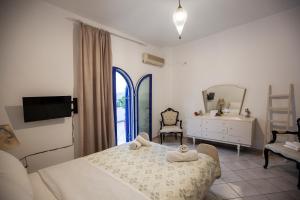 a bedroom with a bed and a dresser and a mirror at Hara's Studio in Perdika
