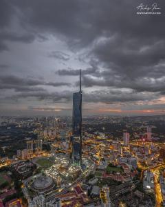 an aerial view of a city with a tall building at Millennium Suite At Opus Residence in Kuala Lumpur